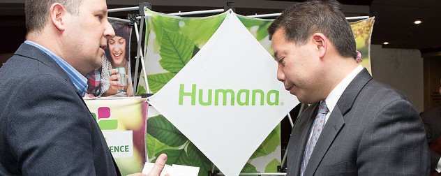 Human logo on a display, with then-Deputy Secretary of Labor Chris Lu