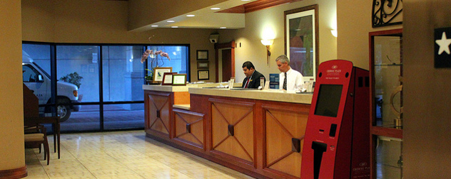 two employees at a reception desk of a San Jose-area Crowne Plaza hotel