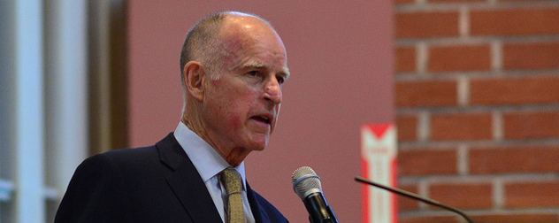 Jerry Brown speaking at a microphone