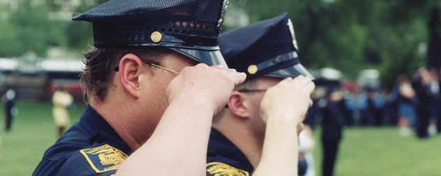 saluting police officers with Hartford, CT insignia on their arms