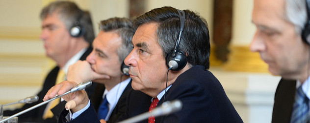 Francois Fillon wearing headphones and in front of a microphone at an EPP summit