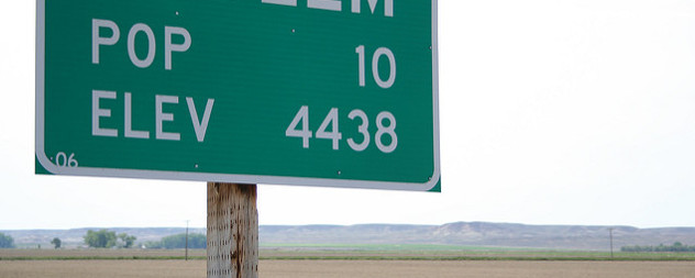 detail of highway sign reading POP 10 ELEV 4438