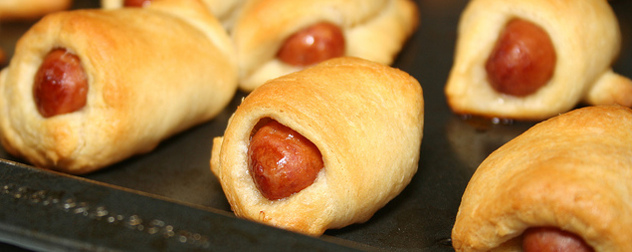 close-up of pigs in a blanket on a baking sheet