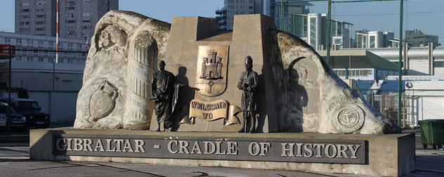 Monument with statues and a plaque that reads Welcome to Gibraltar - Cradle of History