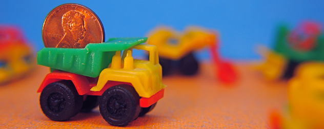 tiny toy dump truck carrying a penny