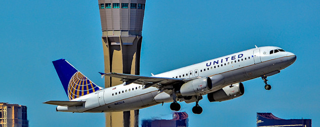 United airplane taking off in front of an air control tower in Las Vegas