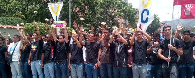 Venezuelan protesters carrying signs and white flowers