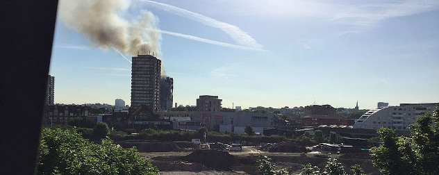 Grenfell Tower seen in the distance, giving off smoke