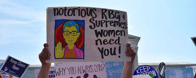 protest sign with illustration of Ruth Bader Ginsburg and text 'notorious RBG & Supremes women need you!'