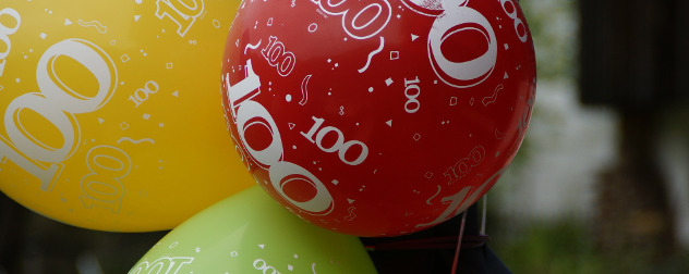 close view of colorful balloons with '100' printed on them