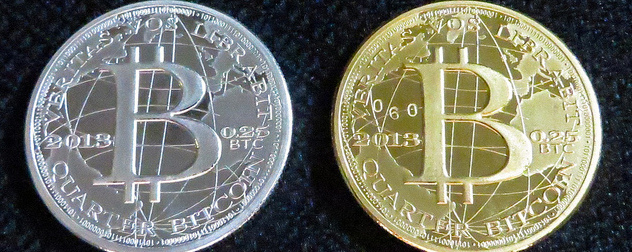 silver and gold colored coins with the bitcoin logo