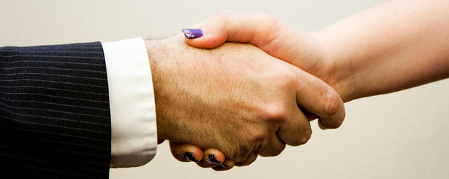 handshake with a person in a suit and a person with painted nails