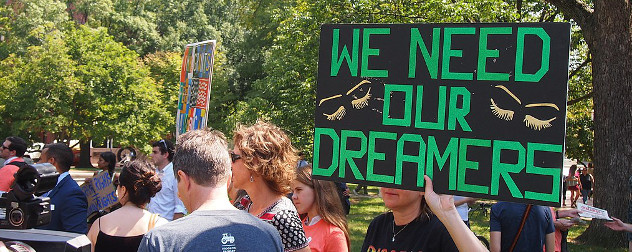 protester holding a sign that says We Need our DREAMERS