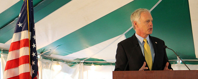 Sen. Ron Johnson speaking at a lectern, with an American flag