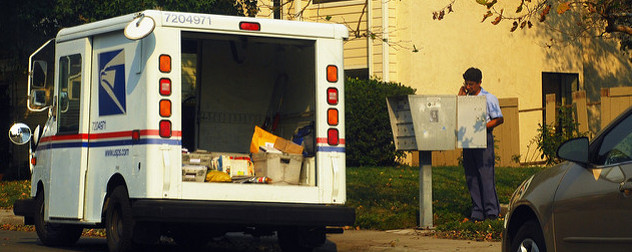 USPS from behind, open to reveal packages for delivery