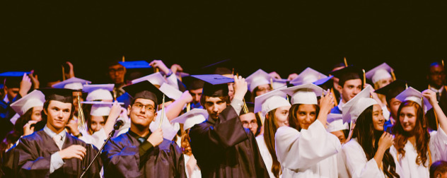 people in caps and gowns moving their tassles