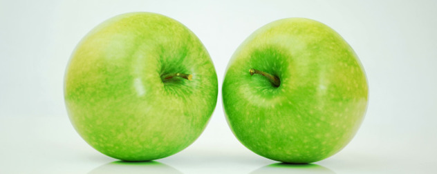 two green apples against a white background