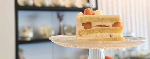 slice of wedding cake on a pedestal stand