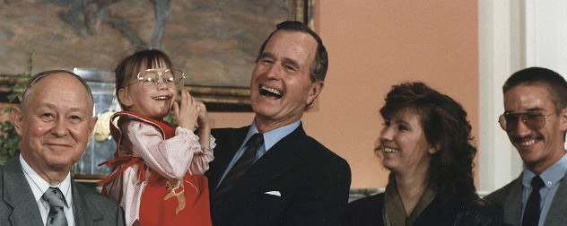 President George H.W. Bush holds Jessica McClure