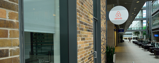 Airbnb logo on a glass door