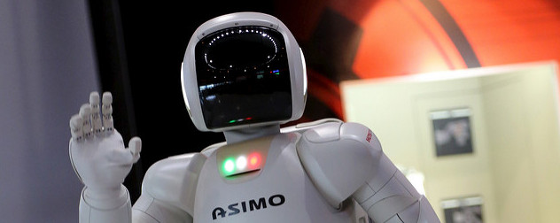 Asimo, a humanoid robot by Honda, waving at the camera