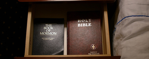 a Bible and a Book of Mormon in a nightstand drawer