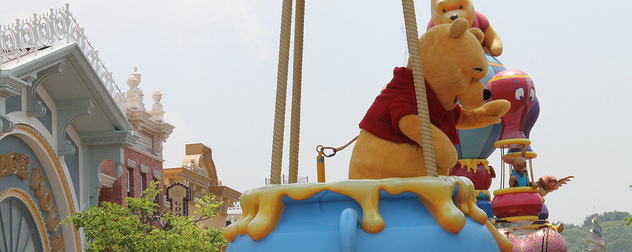 actor in Winnie the Pooh costume in a Hong Kong Disneyland parade