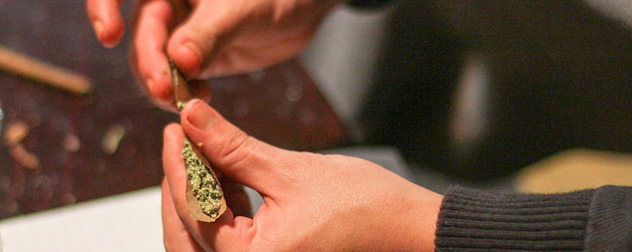 detail of hands rolling marijuana into a joint