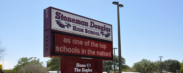 Marjory Stoneman Douglas High School sign, with the partial digital message 'as one of the top schools in the nation!'