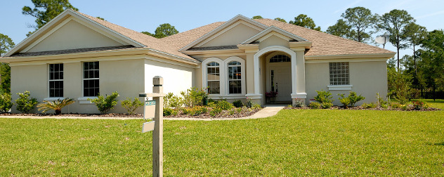 suburban house with For Sale sign in front