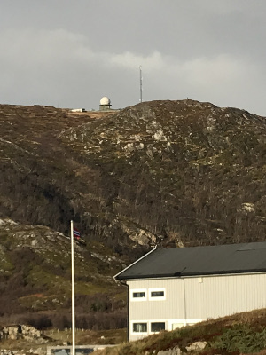 radar dome and radio mast at top of a hill