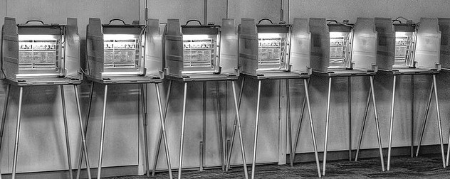 black and white image of voting booths used in the 2018 midterm elections