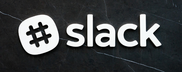 Slack logo against a black stone wall.