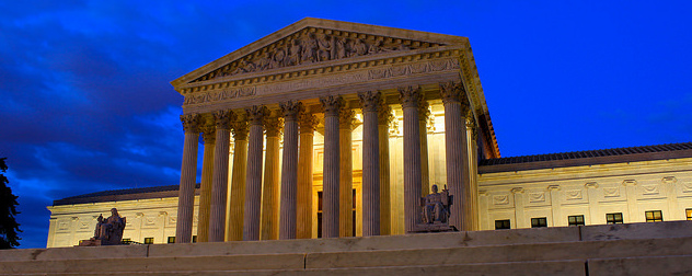 U.S. Supreme Court facade at night.