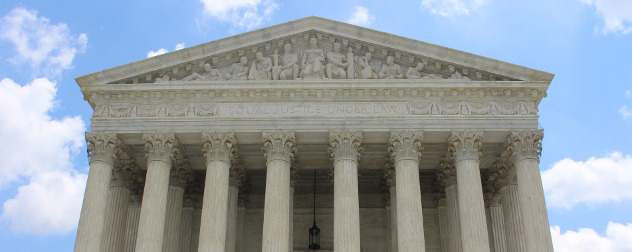U.S. Supreme Court facade against a blue sky.