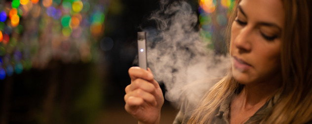 a woman vaping an e-cigarette, detail.