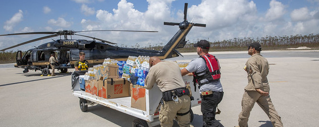 U.S. Customs and Border Protection loading disaster relief supplies onto a helicopter.