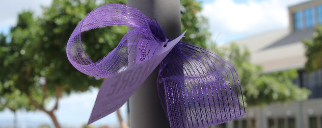 purple ribbon around a pole.