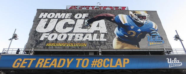 billboard advertising UCLA football, part of the NCAA's Pac-12 conference.