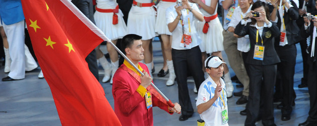 basketball star Yao Ming carrying a Chinese flag at the Summer Olympics opening ceremony, 2008.