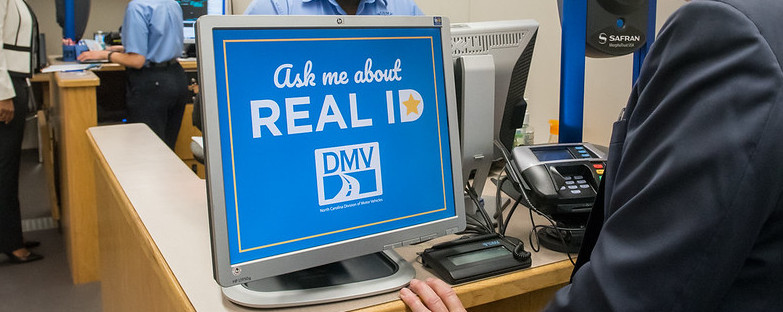 'Ask Me About Real ID' sign at a DMV.