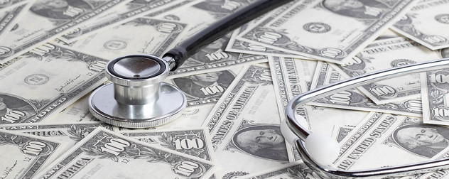 stethoscope resting on a pile of U.S. currency (modified $1 bills).