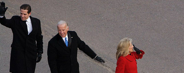 Hunter Biden, Joe Biden and Jill Biden waving while walking in a parade.