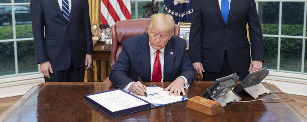 President Trump signing the Families First Coronavirus Response Act in the Oval Office.