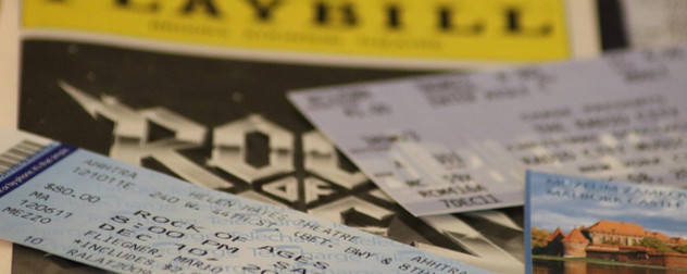 Broadway ticket, Playbill, museum tickets in soft focus.