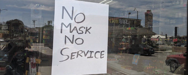 sign in store window that reads 'No Mask No Service'.