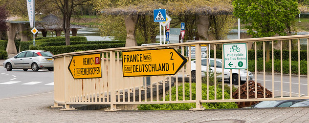 sign indicating the direction of the French and German borders in Schengen, Luxembourg.