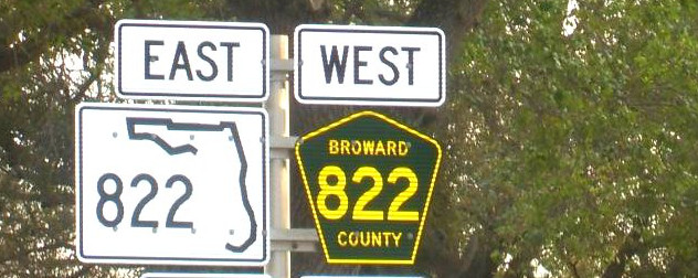 road sign indicating Florida State Road 822 to the East and Broward County Road 822 to the West.