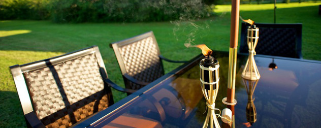 outdoor table with umbrella and torches