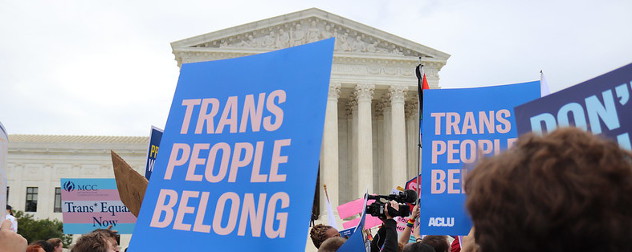 protesters outside the U.S. Supreme Court with signs, including one that reads 'Trans People Belong.'